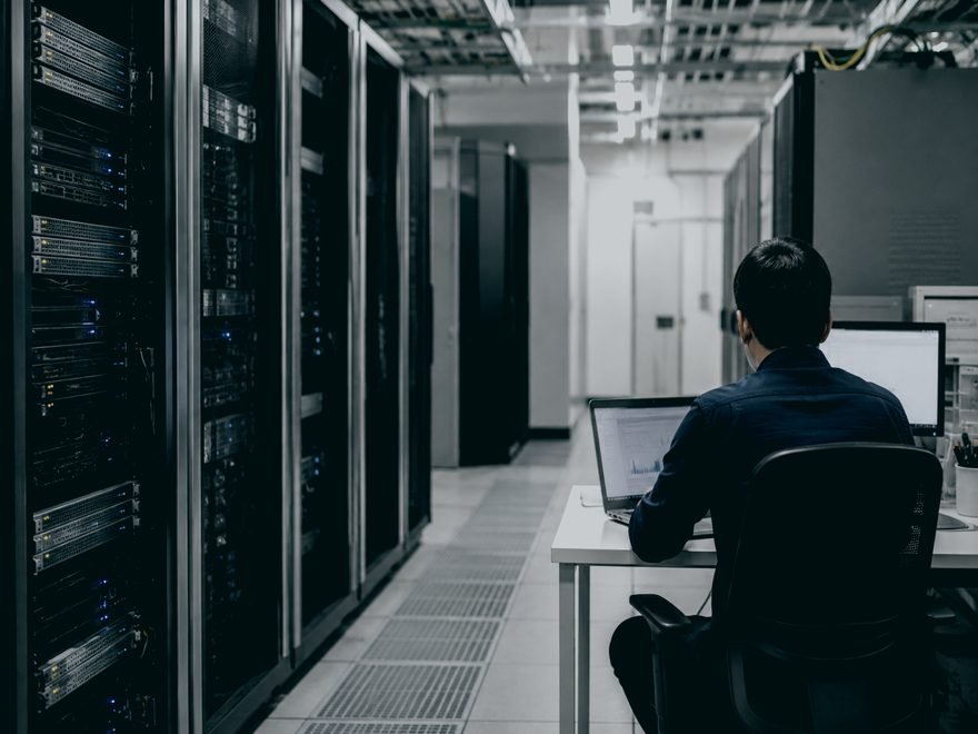 Data centre aisle with an engineer at work